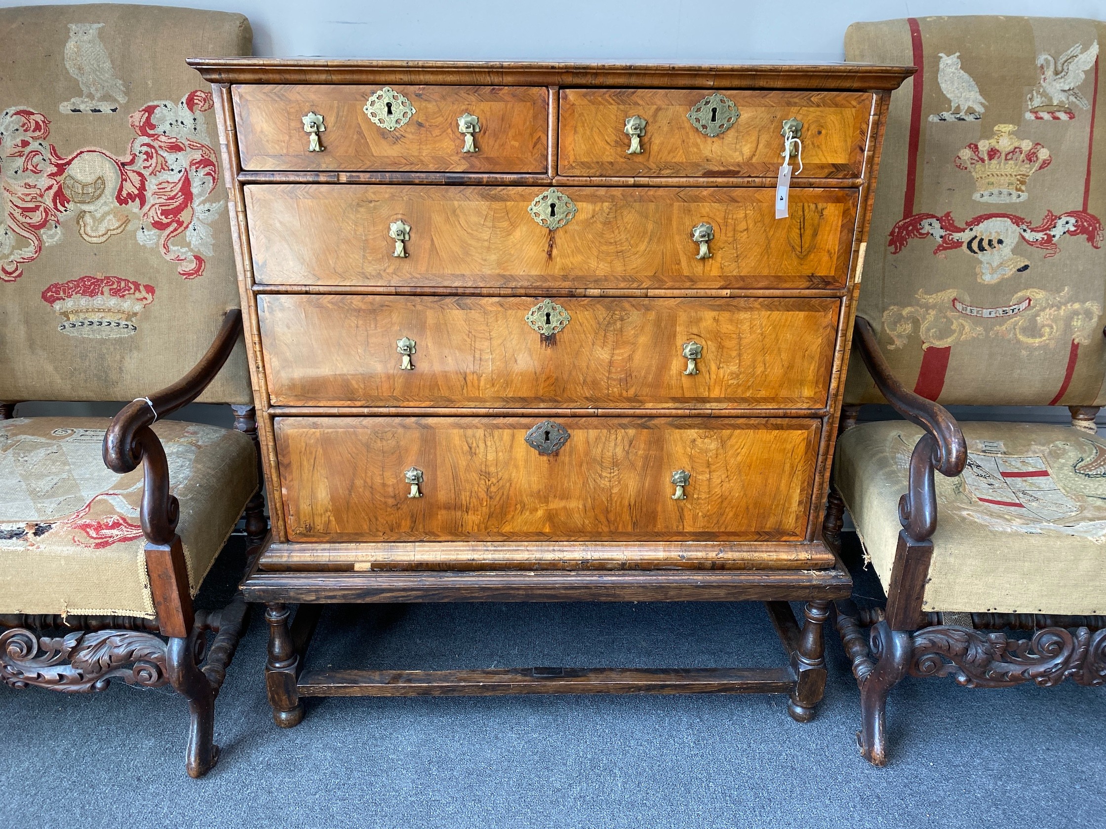 An 18th century feather banded walnut chest on stand, width 96cm, depth 58cm, height 109cm